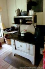 a traditional stove with a kettle and pots